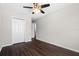 Bedroom with ceiling fan, closet, and dark wood floors at 7022 Chatum Light Run, Bradenton, FL 34212