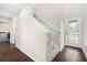 Entryway with staircase, dark hardwood floors, and laundry room at 7022 Chatum Light Run, Bradenton, FL 34212