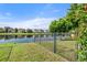 Backyard with a fenced area and lake view at 7022 Chatum Light Run, Bradenton, FL 34212