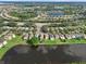 Aerial view of community with lakefront homes and landscape at 7022 Chatum Light Run, Bradenton, FL 34212