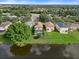 Aerial view of a house with a pool and a beautiful lake view at 7022 Chatum Light Run, Bradenton, FL 34212