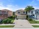 Tan two-story house with attached garage and landscaping at 7022 Chatum Light Run, Bradenton, FL 34212