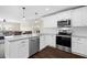Modern kitchen with white cabinets, granite countertops, and stainless steel appliances at 7022 Chatum Light Run, Bradenton, FL 34212