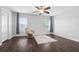 Upstairs bedroom with dark hardwood floors and ceiling fan at 7022 Chatum Light Run, Bradenton, FL 34212