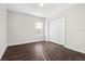 Bright bedroom with dark wood floors and large closet at 7022 Chatum Light Run, Bradenton, FL 34212