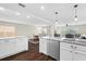Modern kitchen with white cabinets, granite countertops, and stainless steel appliances at 7022 Chatum Light Run, Bradenton, FL 34212