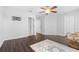 Upstairs bedroom with dark hardwood floors and ceiling fan at 7022 Chatum Light Run, Bradenton, FL 34212