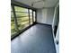 Sunroom with glass windows and gray flooring at 20437 Midway Blvd, Port Charlotte, FL 33952
