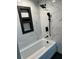 Modern bathroom with soaking tub, black matte fixtures, and marble-look tile at 20437 Midway Blvd, Port Charlotte, FL 33952