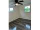 Bright bedroom featuring wood-look flooring and ceiling fan at 20437 Midway Blvd, Port Charlotte, FL 33952