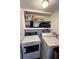 Laundry room with washer, dryer, and overhead shelving at 20437 Midway Blvd, Port Charlotte, FL 33952