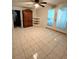 Bedroom with tiled floors, built-in shelving, and patio doors at 20437 Midway Blvd, Port Charlotte, FL 33952