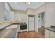 White kitchen cabinets, dark countertops, and tile floor at 1677 4Th St, Sarasota, FL 34236