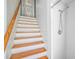 Staircase with wood steps and white risers at 1677 4Th St, Sarasota, FL 34236