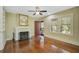 Living room with hardwood floors, fireplace, and ceiling fan at 1677 4Th St, Sarasota, FL 34236