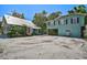 Two-building property with a large gravel driveway at 1677 4Th St, Sarasota, FL 34236