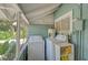 Laundry room with washer, dryer, and overhead storage at 1677 4Th St, Sarasota, FL 34236