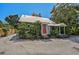 Quaint cottage with red door and tropical landscaping at 1677 4Th St, Sarasota, FL 34236