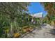 Charming home with a gravel driveway and lush gardens at 1677 4Th St, Sarasota, FL 34236
