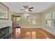 Living room with hardwood floors, fireplace, and ceiling fan at 1677 4Th St, Sarasota, FL 34236