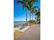 Scenic waterfront park bench under palm trees at 1677 4Th St, Sarasota, FL 34236
