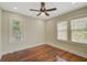Well-lit bedroom featuring hardwood floors and ceiling fan at 1677 4Th St, Sarasota, FL 34236