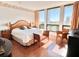 Large main bedroom with king-size bed and golf course view at 1065 Gulf Of Mexico Dr # 302, Longboat Key, FL 34228
