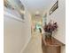 Bright and airy hallway with wood accent table at 325 Maraviya Blvd, Nokomis, FL 34275