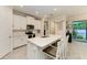 Modern kitchen with white cabinets, quartz countertops, and an island with seating at 325 Maraviya Blvd, Nokomis, FL 34275