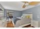 Main bedroom with wood floors, sliding doors, and a ceiling fan at 3917 Cochise Ter, Sarasota, FL 34233