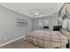 Bedroom with gray walls, window, and plaid bedding at 3917 Cochise Ter, Sarasota, FL 34233
