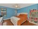 Bedroom with orange bedding, white headboard, and built-in shelving at 3917 Cochise Ter, Sarasota, FL 34233