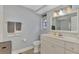 Clean bathroom with white vanity, mirror, and light blue walls at 3917 Cochise Ter, Sarasota, FL 34233
