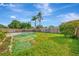 Large backyard with a fenced pool and grassy area at 3917 Cochise Ter, Sarasota, FL 34233