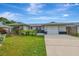 Single story home with a large yard, driveway and mature landscaping at 3917 Cochise Ter, Sarasota, FL 34233