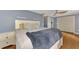 Main bedroom with plush bedding, wood floors, and built-in closet at 3917 Cochise Ter, Sarasota, FL 34233