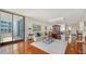 Open living room with hardwood floors and access to balcony at 1255 N Gulfstream Ave # 1003, Sarasota, FL 34236