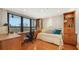 Bedroom with built-in bookcases and hardwood floors at 1255 N Gulfstream Ave # 1003, Sarasota, FL 34236
