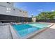 Community pool with patio furniture and seating at 1255 N Gulfstream Ave # 1003, Sarasota, FL 34236