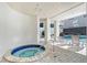 Community hot tub with adjacent lounge chairs at 1255 N Gulfstream Ave # 1003, Sarasota, FL 34236