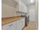 Laundry room with granite countertops, ample cabinet space, and washer/dryer hookups at 22408 76Th E Ave, Bradenton, FL 34211