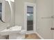 Stylish bathroom with updated fixtures, a pedestal sink, and private access at 22408 76Th E Ave, Bradenton, FL 34211
