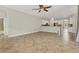 Open living room with tile floors, kitchen and breakfast bar views, access to screened lanai at 22408 76Th E Ave, Bradenton, FL 34211