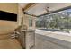 Outdoor kitchen and screened-in pool with spa and fountain at 22408 76Th E Ave, Bradenton, FL 34211
