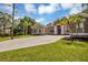 House exterior showcasing a large driveway and lush landscaping at 22408 76Th E Ave, Bradenton, FL 34211