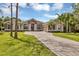 Two-story house with stone accents, three-car garage, and manicured lawn at 22408 76Th E Ave, Bradenton, FL 34211