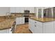Modern kitchen with granite countertops, stainless steel appliances and white cabinets at 22408 76Th E Ave, Bradenton, FL 34211