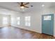 Living room with light wood floors and blue door at 710 N Thomas St, Plant City, FL 33563