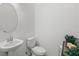 Simple and clean bathroom with pedestal sink, toilet, and oval mirror at 4119 Via Sienna Cir, Sarasota, FL 34243