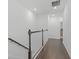 Upstairs hallway with dark hardwood floors and white railings at 4119 Via Sienna Cir, Sarasota, FL 34243
